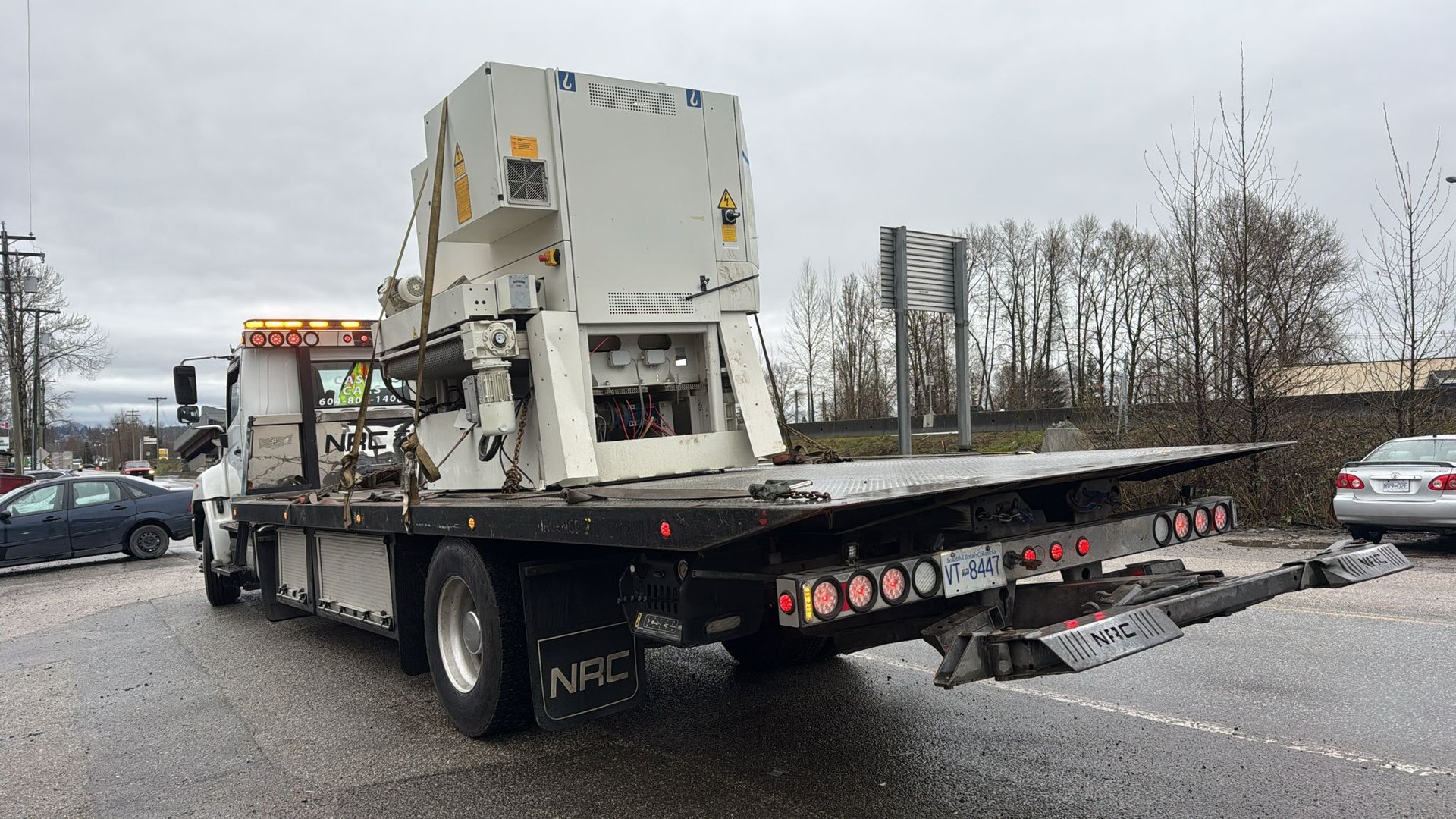 Industrial equipment removal in Langley - heavy factory unit secured on flatbed